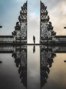 man standing between ruins in reflective photography